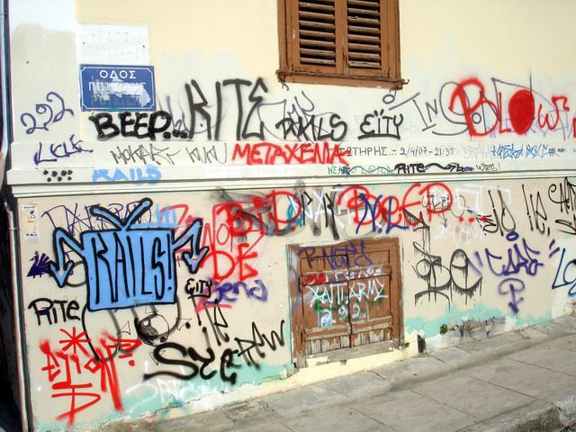 grafitti on a restored neoclassical house in Plaka, Athens